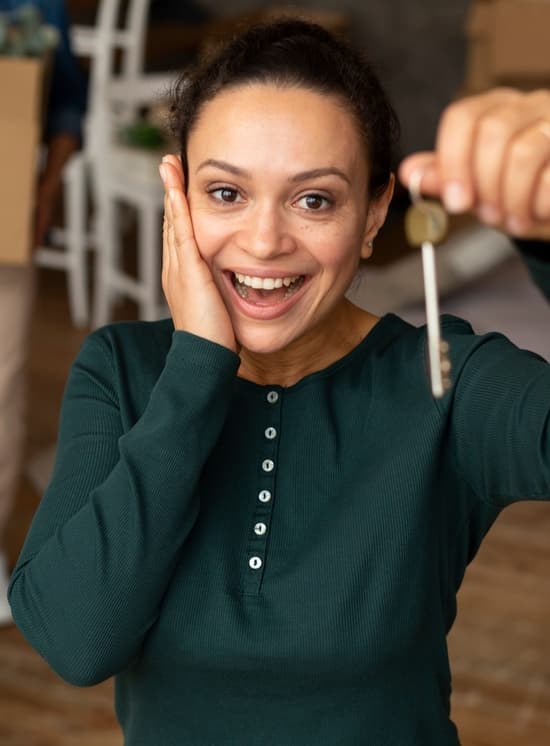 Happy homeowner holding keys